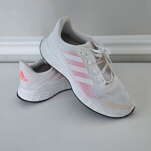 Adidas Duramo SL women's running shoe in white with pink accents. 